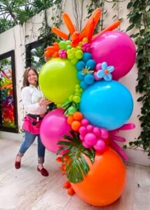 Balloon designer with colorful design garland